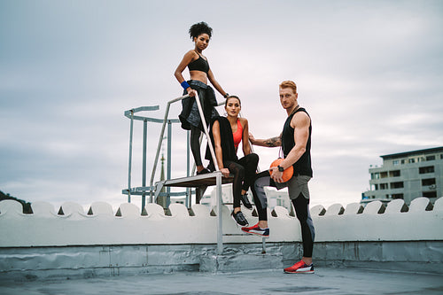Group of athletes standing on rooftop after workout