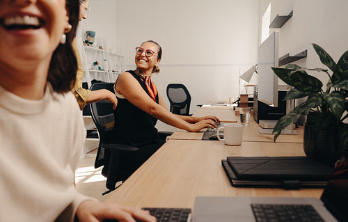 Colleagues sharing a cheerful moment in a professional office workspace