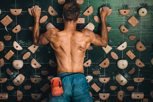 Man climbing indoor boulder wall