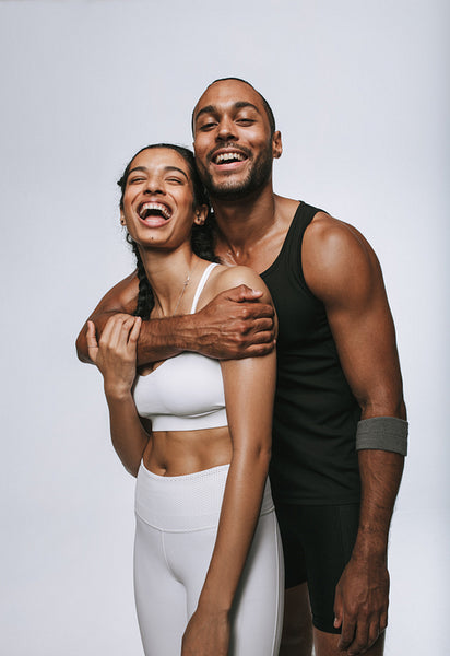Monochrome portrait of laughing fit couple