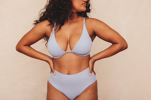 Confident young woman wearing underwear in a studio