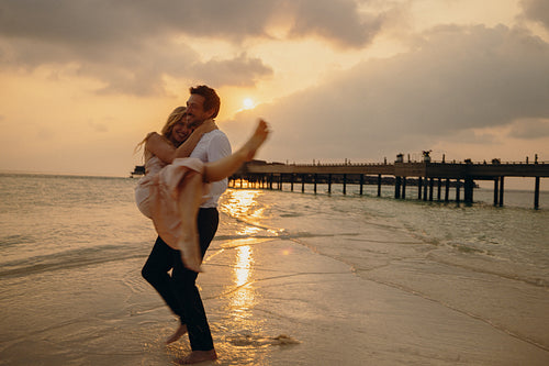 Serenity in luxury: Beautiful couple's honeymoon sunset beach bliss