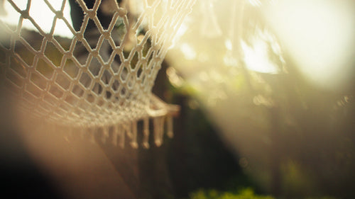 Close-up of hammock swaying in warm island breeze