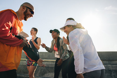 Friends celebrating after completing a race together outdoors