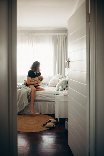 Woman with baby in bedroom