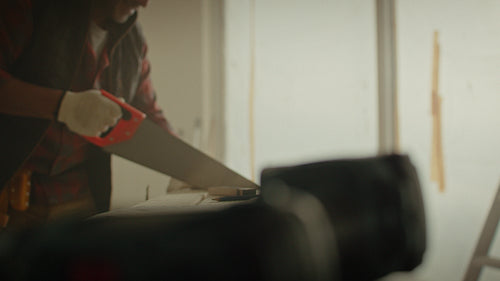 Transforming a space: A man cuts lumber for home renovation