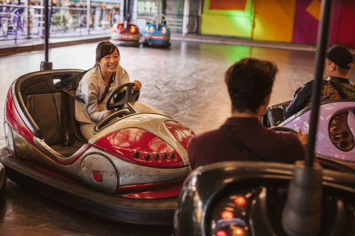 Friends having fun on bumper car ride 