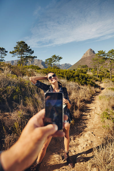 Woman posing for picture while hiking
