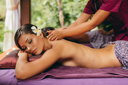 Young woman enjoying a massage at spa