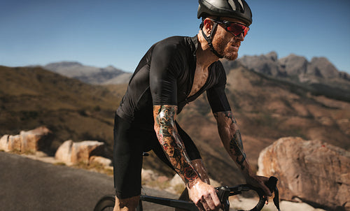 Male cyclist riding hard on pro bike