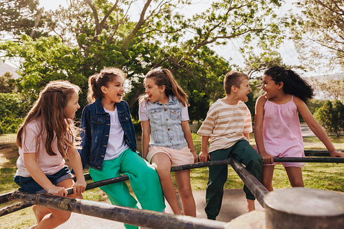 Group of happy children enjoying time together outdoors in sunny weather