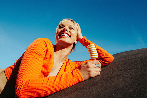 Woman enjoys a popsicle while relaxing in the sun