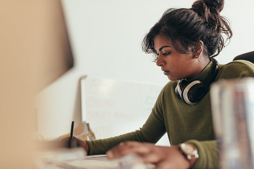 Female computer programmer working at her desk