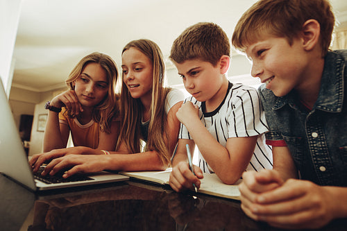 Kids learning together on a laptop