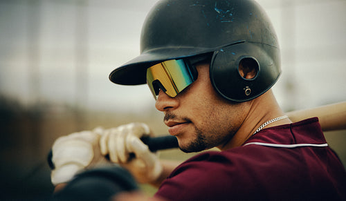 Focused male baseball batter ready to swing with confidence