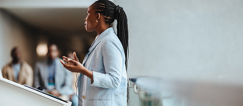 Professional businesswoman giving a speech at a corporate conference meeting