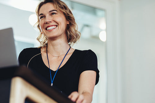Confident woman standing at speaker podium