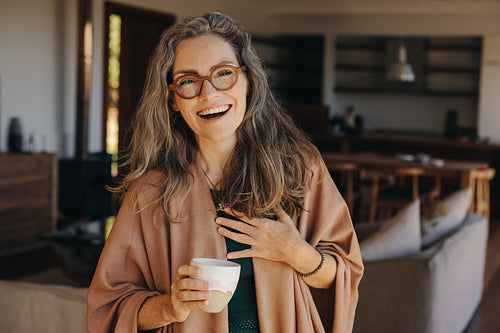 Beautiful senior woman smiling at the camera at home