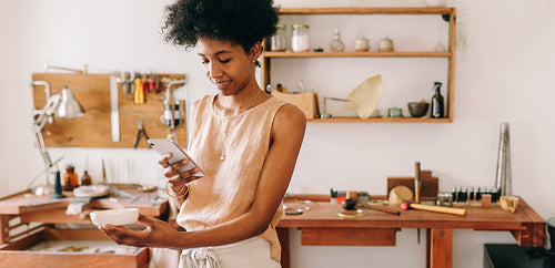 Jeweler doing online selling of jewelry in studio