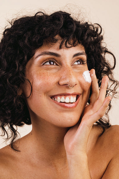 Applying nourishing facial cream