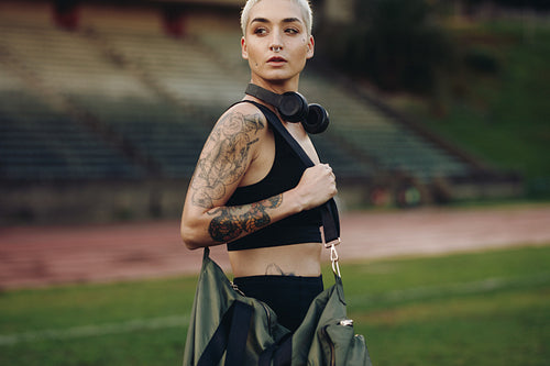 Side view of a female athlete in a stadium