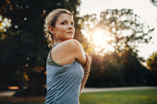 Beautiful young woman exercising in the park