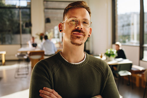 Confident male executive looking at camera in office