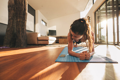 Woman exercising and looking at her mobile phone