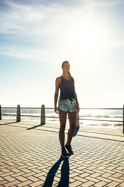 Young woman walking on the sea side promenade