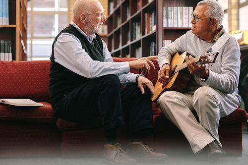 Senior men playing guitar