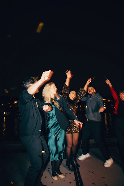 Friends celebrating outdoors during a festive nighttime gathering