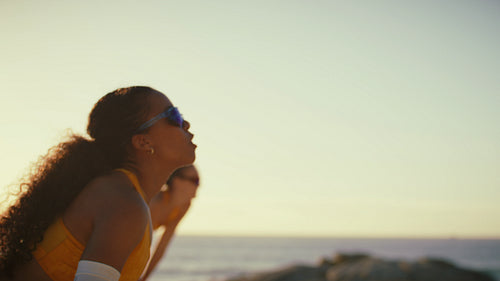 Slow-motion shot of African-American athlete playing professional beach volleyball