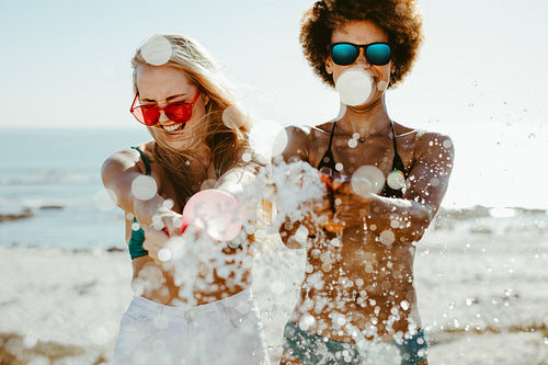 Female friends playing with a water balloon
