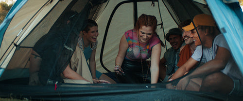 Young friends taking a selfie in a tent at a music festival