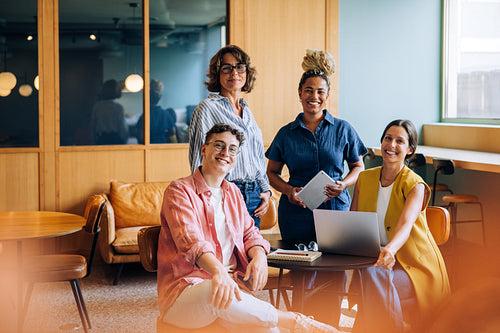 Group of diverse adults gathered in a modern office workspace