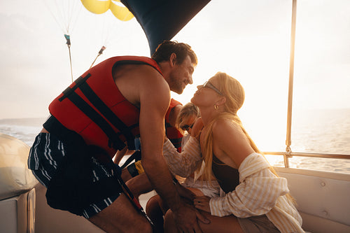 Romantic couple sharing a kiss on an adventurous vacation boat ride