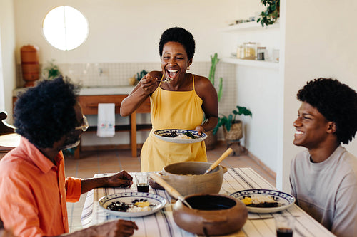 Family enjoying Brazilian cuisine in a happy home kitchen