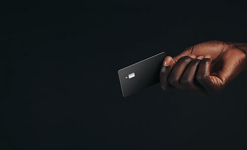 Man making a purchase with a premium bank card using NFC