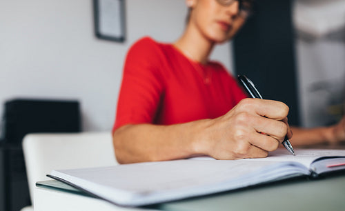 Business woman writing notes