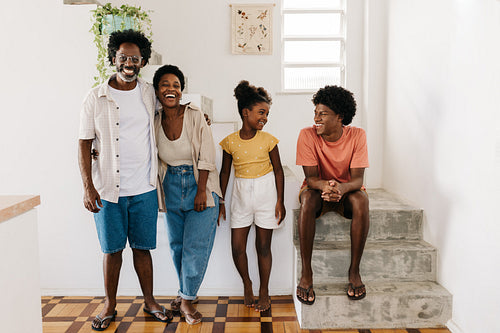 Happy black family laughing and having fun together in their home