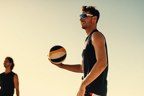 Professional beach volleyball players compete in sunny coastal championship