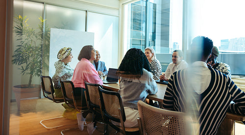 Diverse team engaging in a collaborative business meeting in a modern conference room
