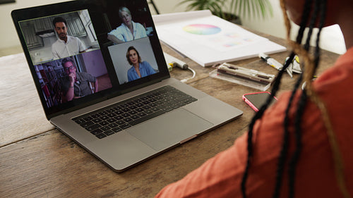 Young artist talking to her business clients on a video call