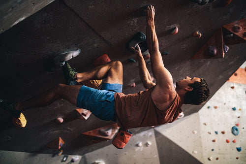 Man climbing indoor boulder wall