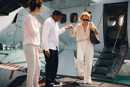 Elegant group arriving at island resort via seaplane assistance