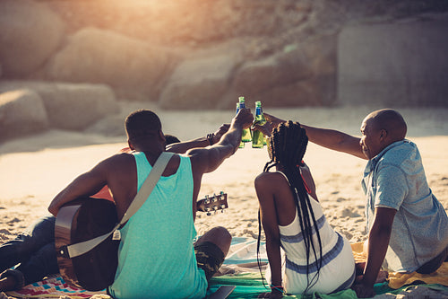 Group of friends having beach party