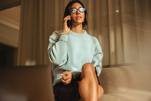 Businesswoman talks on the phone while working in her office