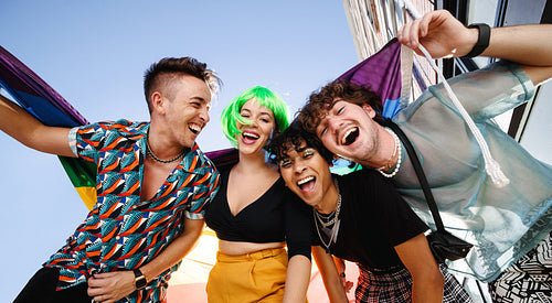 Four young people celebrating their queer identities together