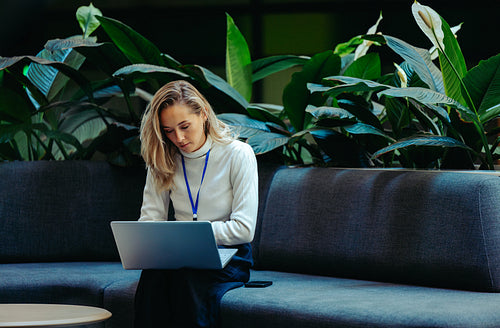 Young female professional working in a sustainable office space