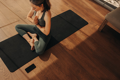 Top view of a mature woman meditating during a yoga session